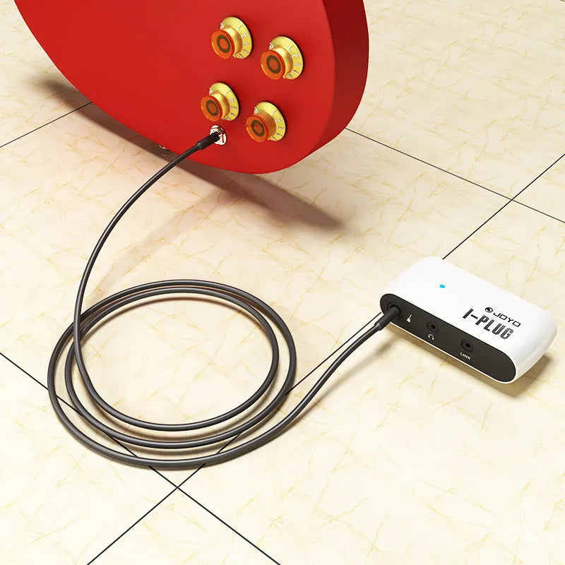 White metal distortion headphone amplifier unit measuring 93mm with connector and adapter for guitar practice