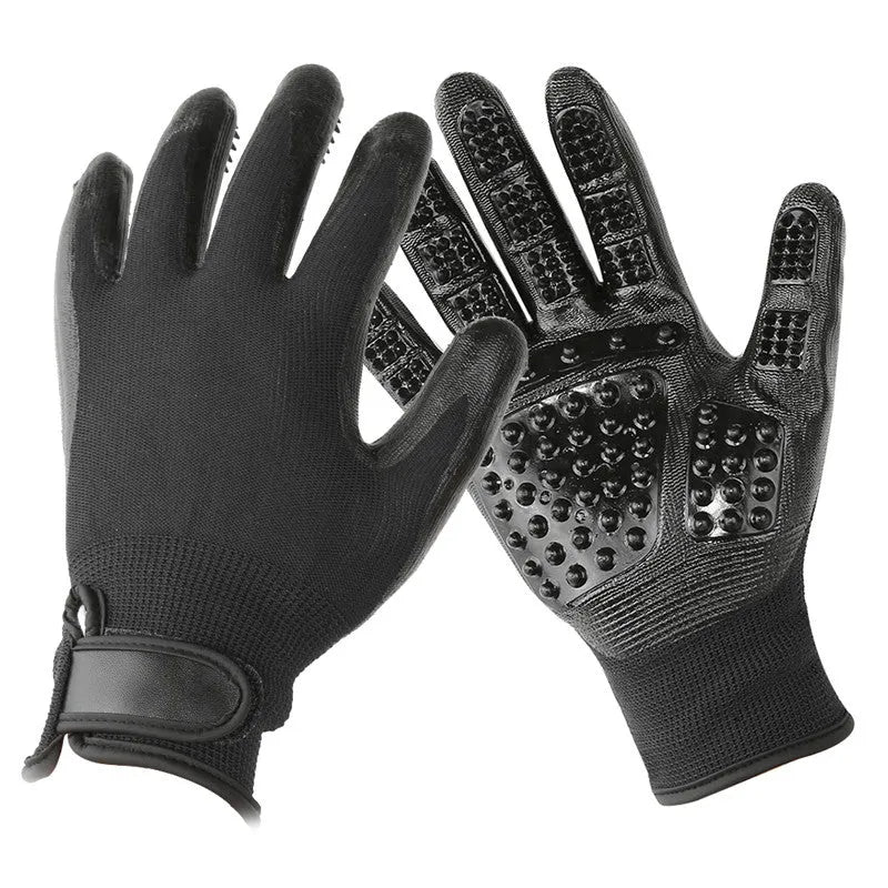 Pet hair grooming glove in black rubber with adjustable wrist strap on a light background
