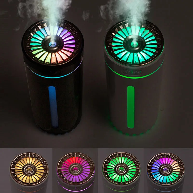 Black portable ultrasonic humidifier with colourful LED lights on a car cup holder.