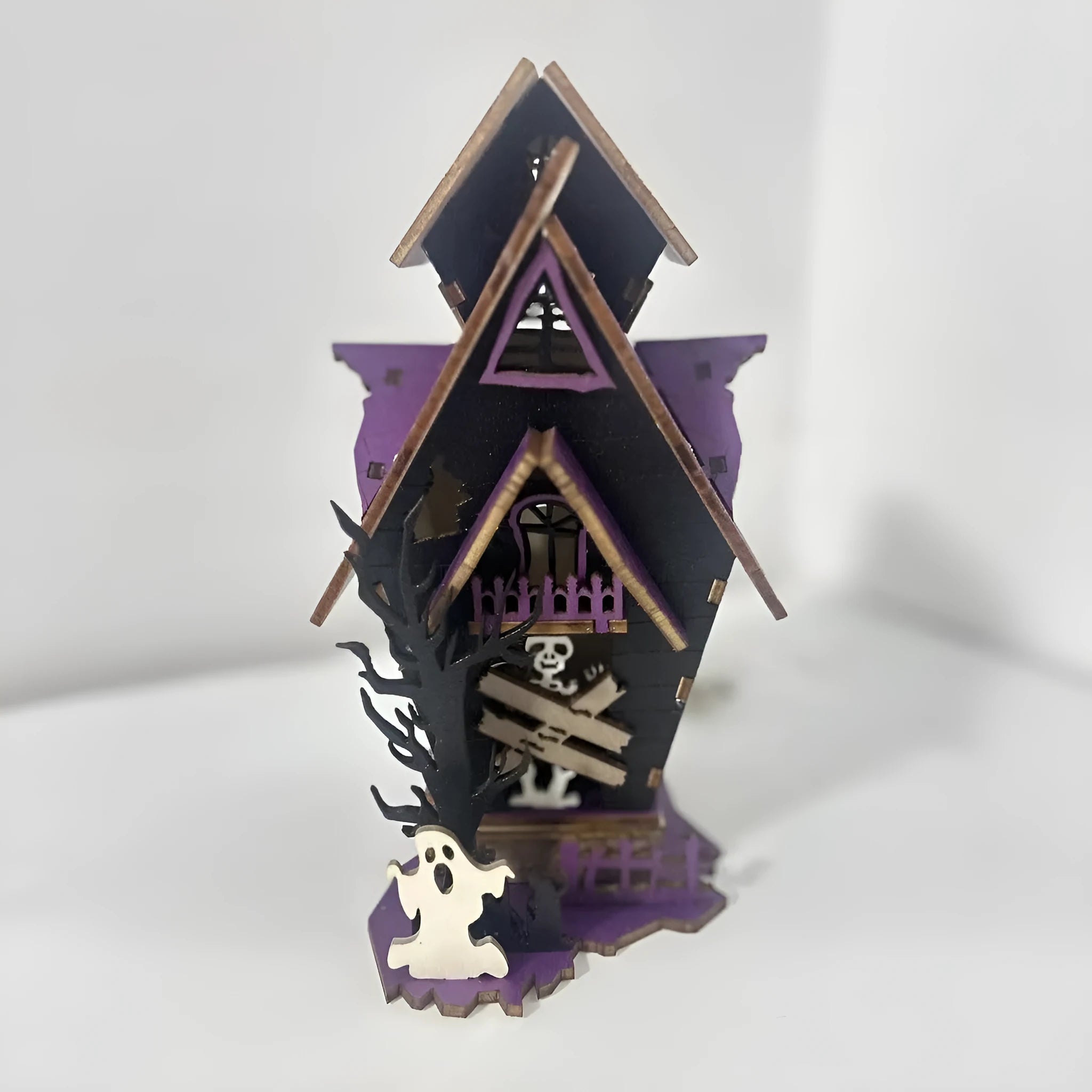 Unpainted DIY wooden haunted house Halloween decoration for use as a candlestick, shown next to a ruler for scale.