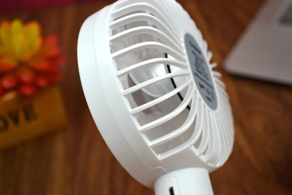 White ORICO FH1 portable USB rechargeable handheld desk fan with three-speed settings.