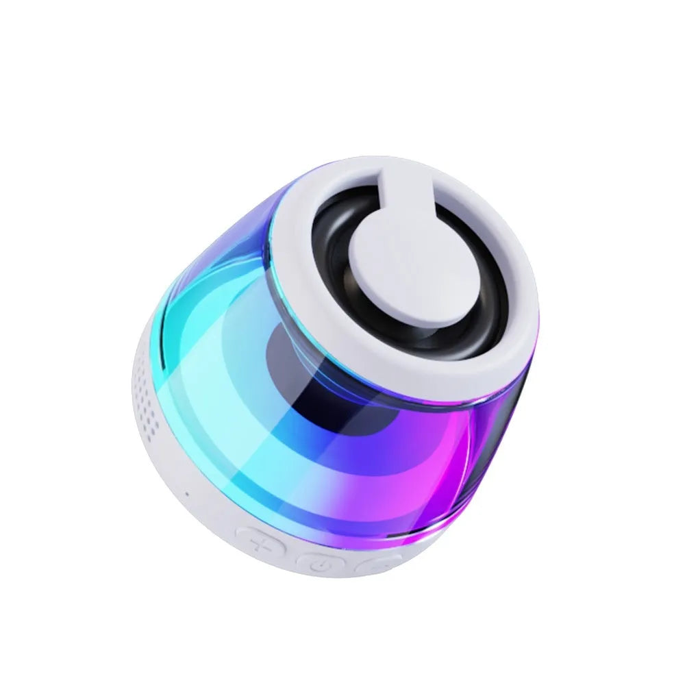 Small portable black Bluetooth speaker with coloured ambient light, shown with a magnetic base.