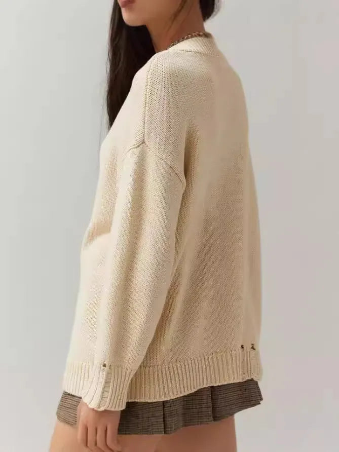 Women's milky white acrylic jacquard knit pullover sweater with a round neck and long sleeves.