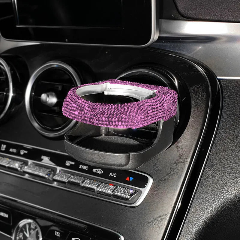 Diamond-decorated car cup holder bracket mounted on air vent in blue rhinestone finish