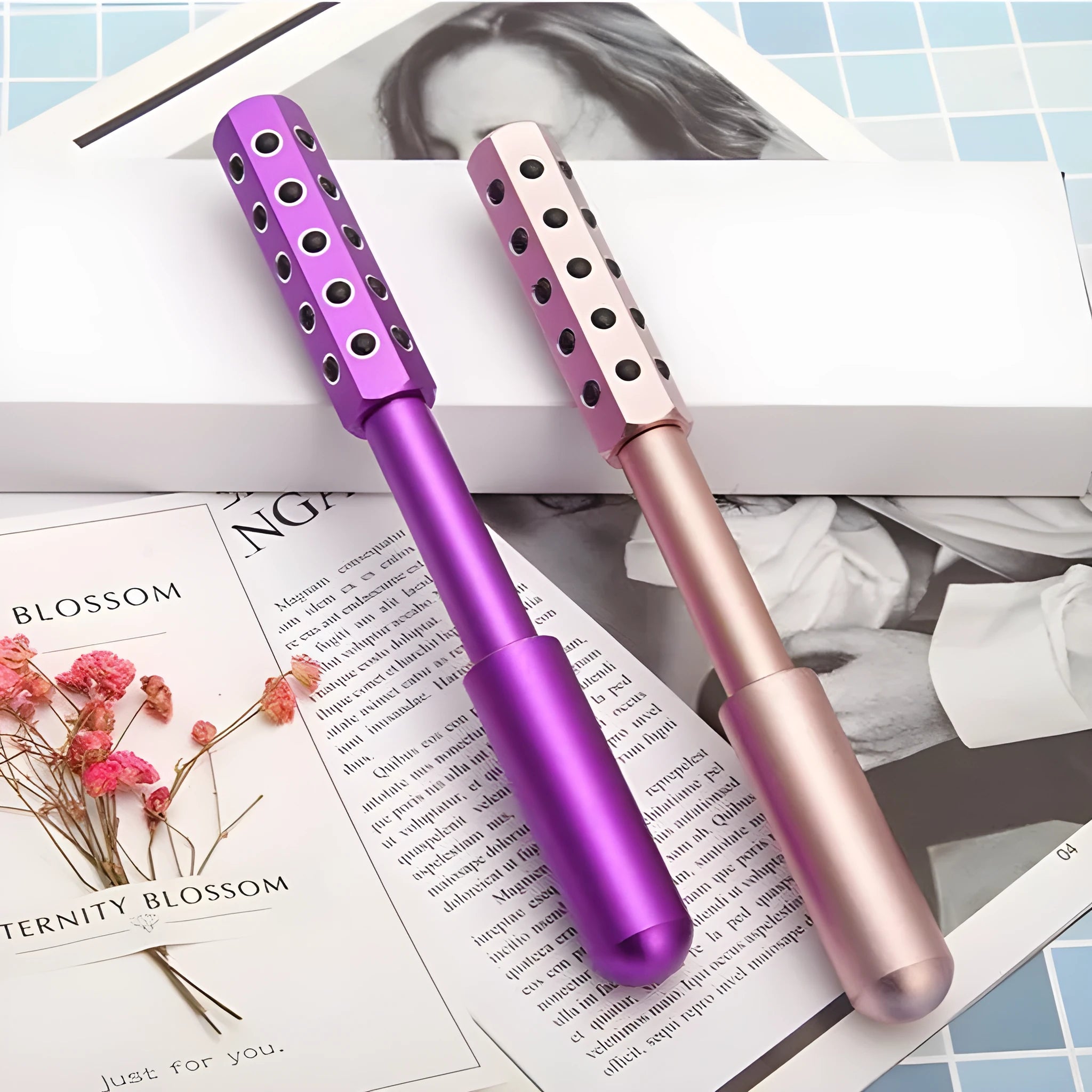 Handheld germanium particles facial massage roller in purple colour on a white background