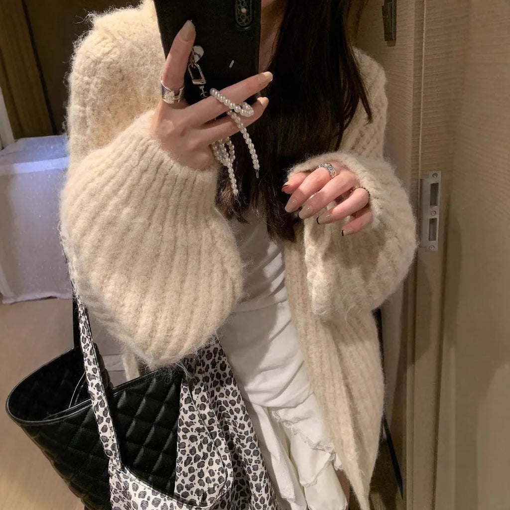 A woman wearing a brown retro-style hooded cardigan with thick knit fabric.