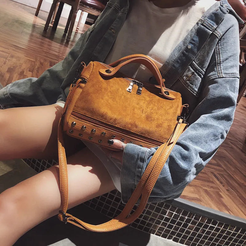 Soft grey PU leather women's tote shoulder bag with zip top on a table