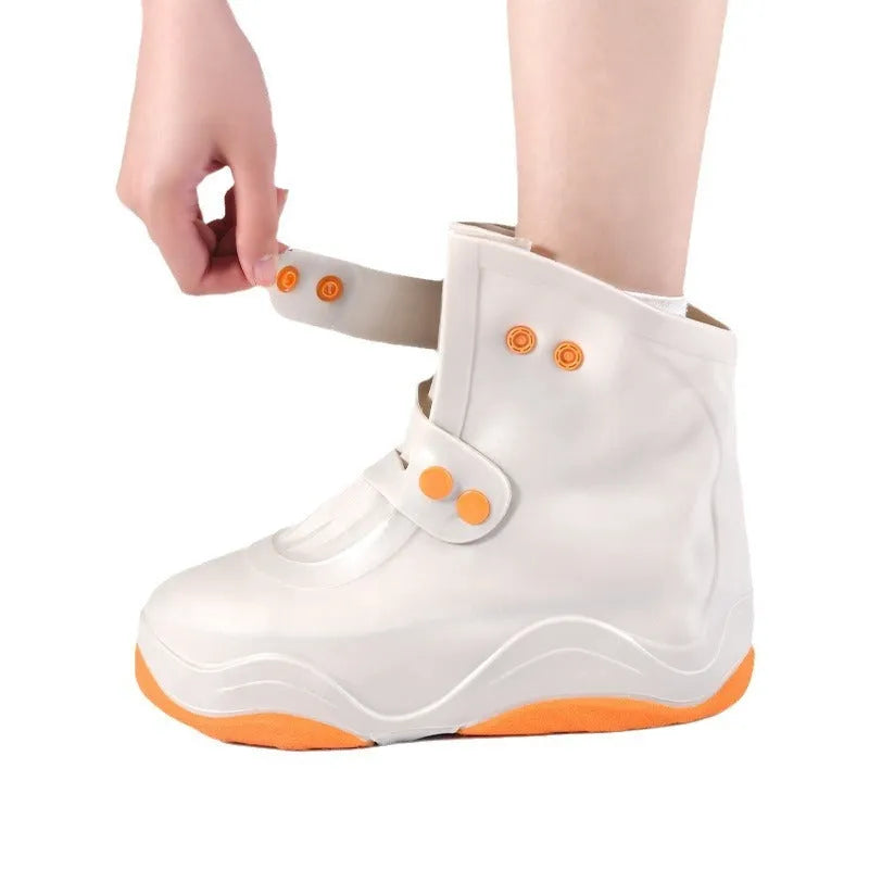 Set of waterproof silicone shoe covers in black, blue, orange, and white with non-slip soles
