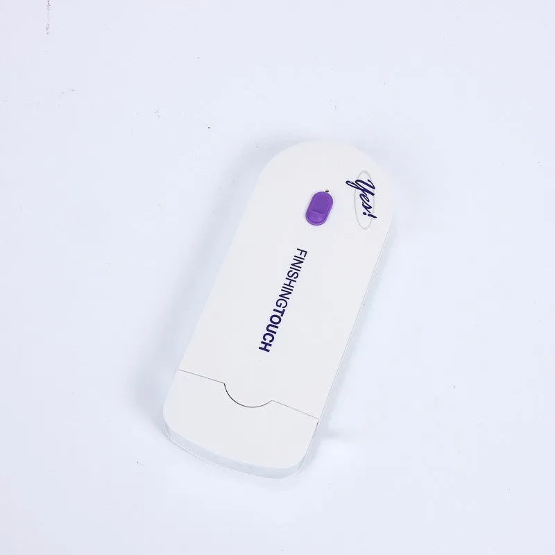 White rechargeable electric hair removal instrument with foil head and cleaning brush on a table.