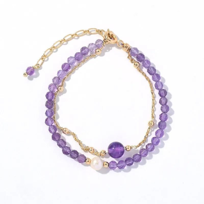 Close-up of a Chinese style women's bracelet with diamond-shaped amethyst crystals and an electroplated finish.