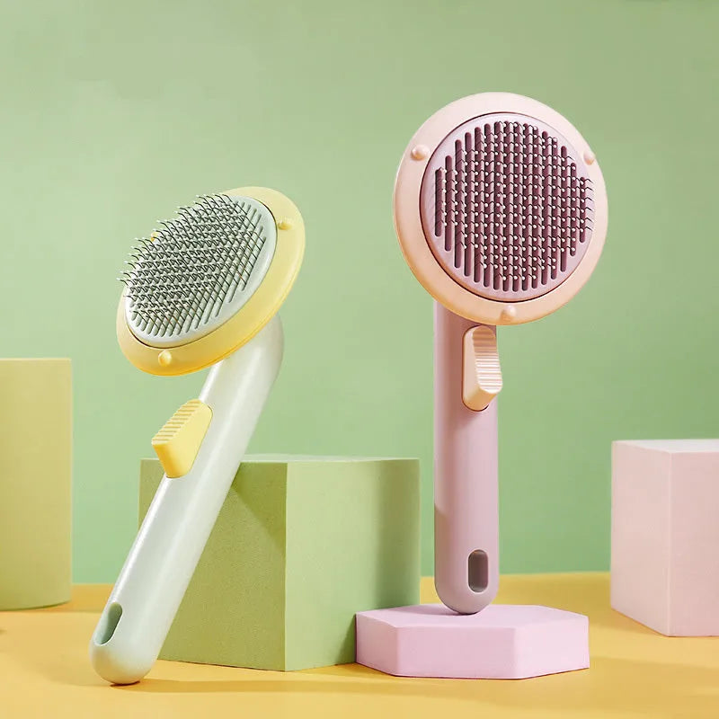 Hand holding a white and pumpkin coloured pet grooming brush with many stainless steel needles.