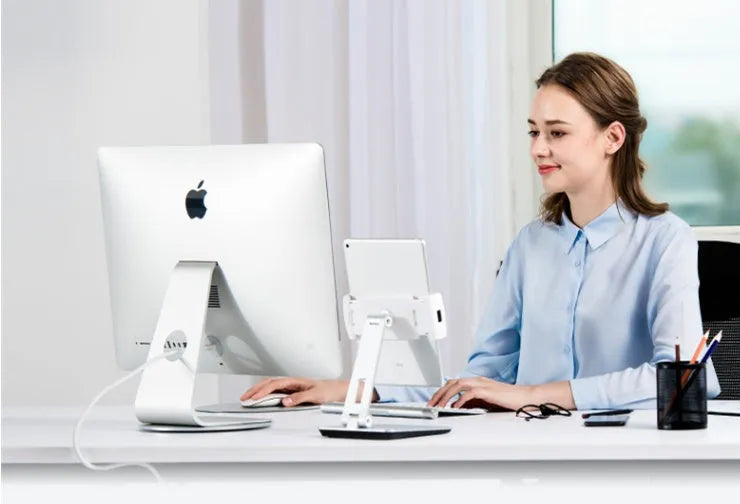 Folding aluminium phone and tablet stand with black silicone pads, shown holding a tablet at an angle.