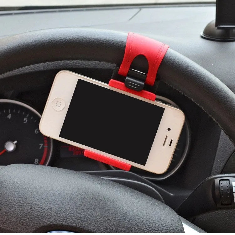 Black universal steering wheel phone holder clip mount attached to a car steering wheel.
