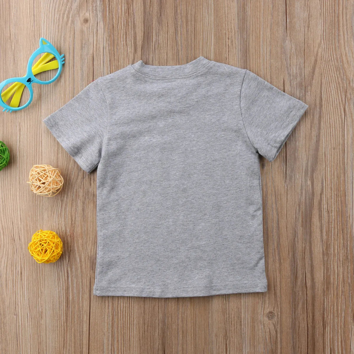 Grey cotton children's t-shirt with printed sibling graphic, showing size range from 60cm to 140cm.