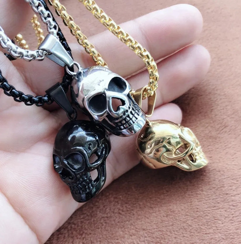 Halloween skull necklace in alloy and stainless steel with gold colour option on a black background
