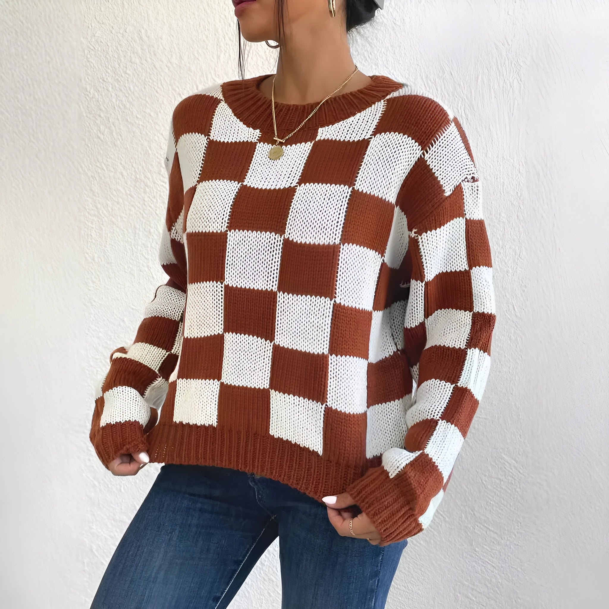 Dark brown loose pullover sweater with a chessboard plaid pattern and round neck.