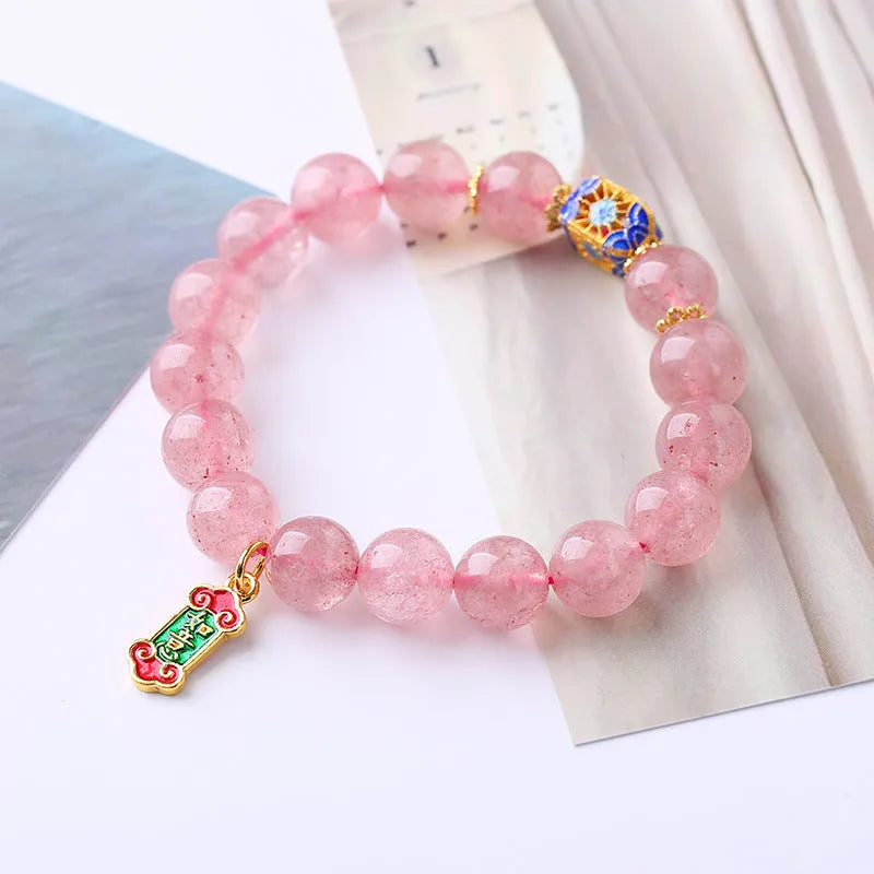 Pink crystal bracelet with hand-woven design featuring Ruyi charm and text elements