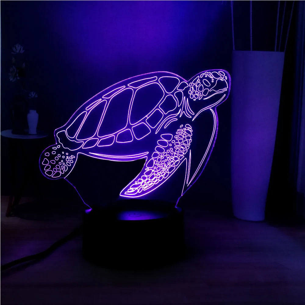 A glowing 3D acrylic turtle-shaped LED night light on a surface, showing its detailed sculpture and soft coloured light.