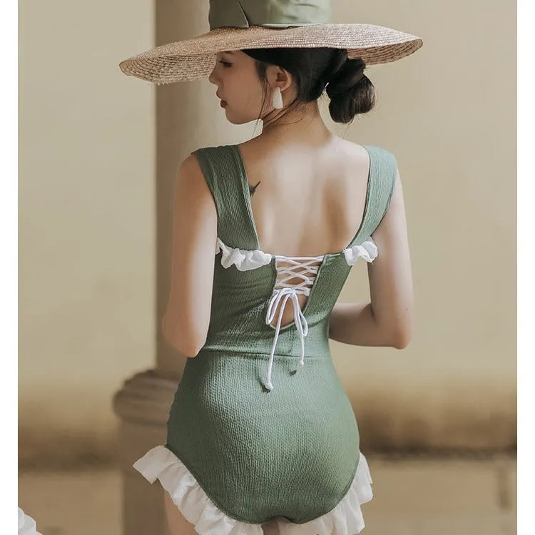 High-waist one-piece swimsuit in Korean style with slimming design available in black, pink, or green colours