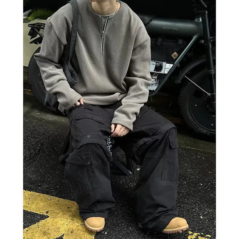 A grey loose-fitting long sleeve women's pullover top hanging flat.