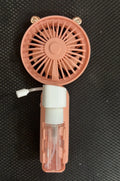Plastic USB rechargeable nozzle fan in apricot colour on a desk.