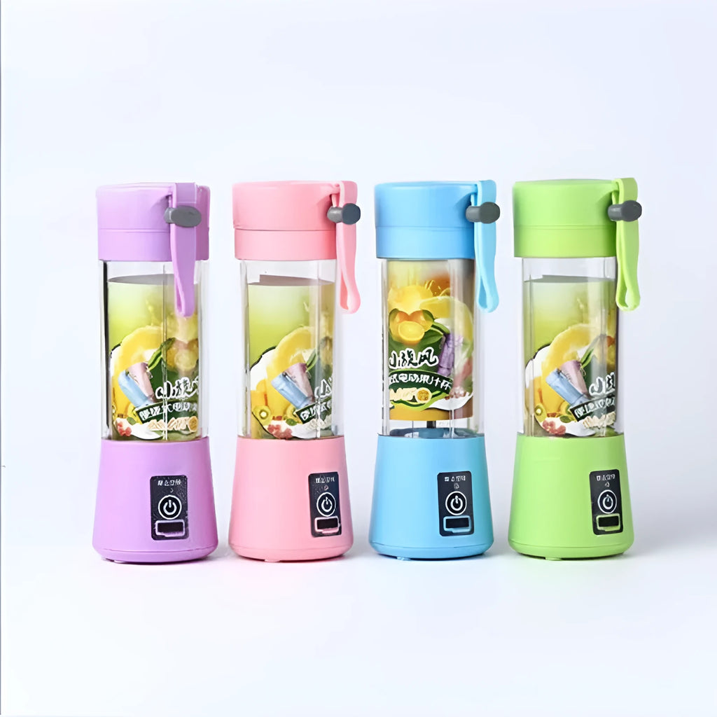Pink mini USB electric centrifugal fruit juicer with stainless steel blade on a table.