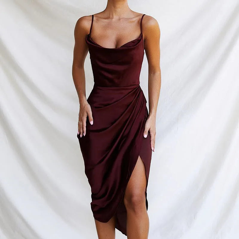 Women's high-waisted satin midi skirt in black with a side slit, laid flat on a white background.