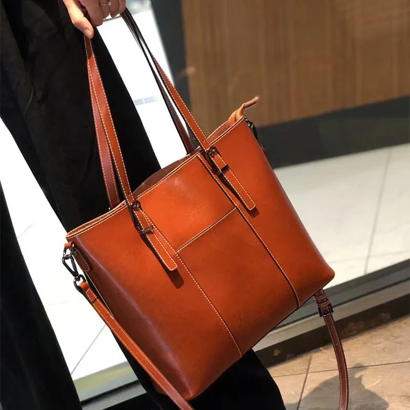 Brown genuine leather retro women's shoulder bag with three straps showing interior organisation compartments