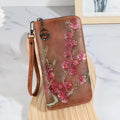 Embossed floral handbag with retro styling and zipper closure