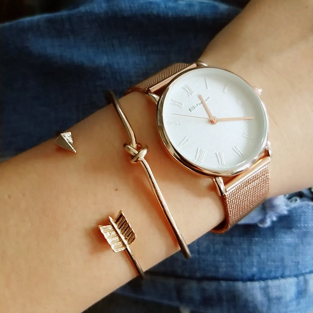 Women's gold vintage cuff bracelet with arrow and knotted design on wrist