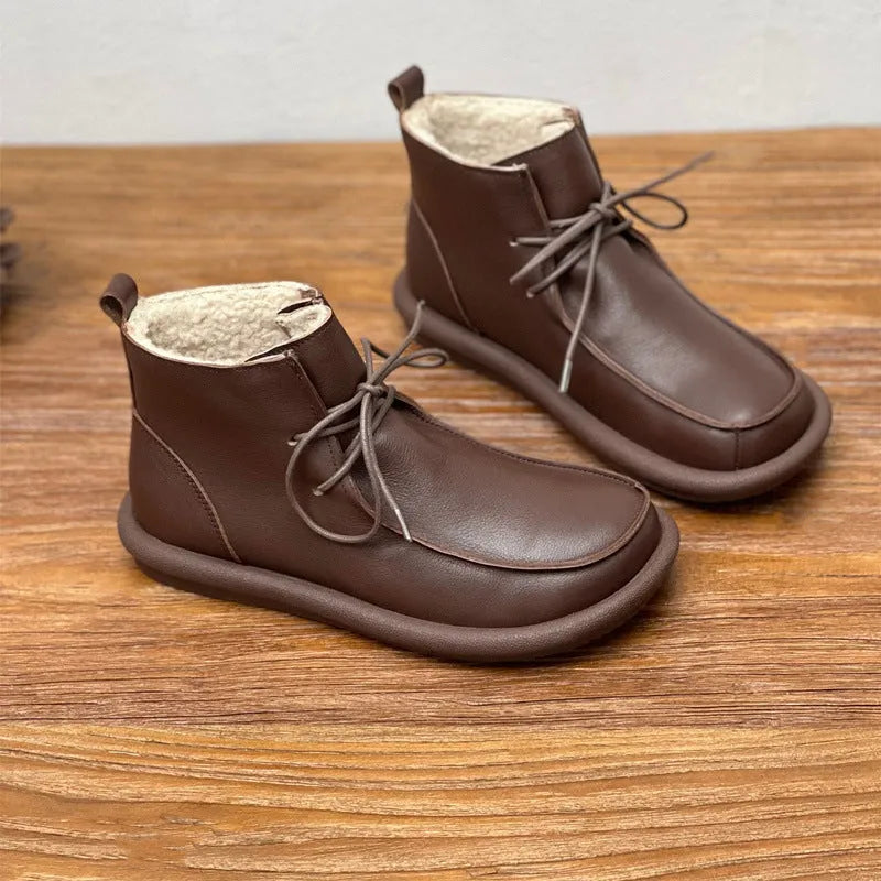 Women's casual cowhide boots with velvet lining in black and coffee colours showing round toe and flat heel design