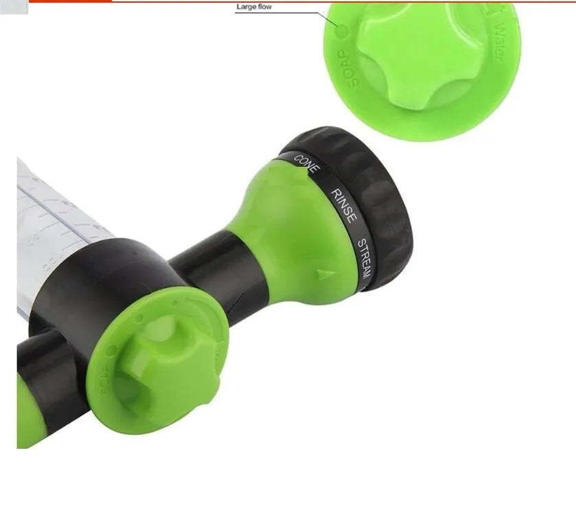 Green high-pressure foam spray gun with adjustable nozzle and connected water hose for car and garden cleaning.