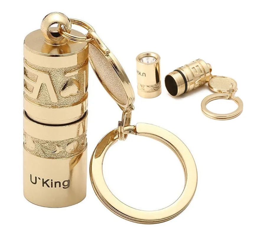 Gold electroplated zinc alloy portable LED keychain flashlight for outdoor emergency use.