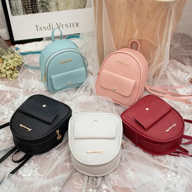 Black PU leather small women's backpack with zipper, shown as a shoulder bag.