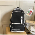 Nylon school backpack in green with pendant, showing curved shoulder straps and sewing line detail.