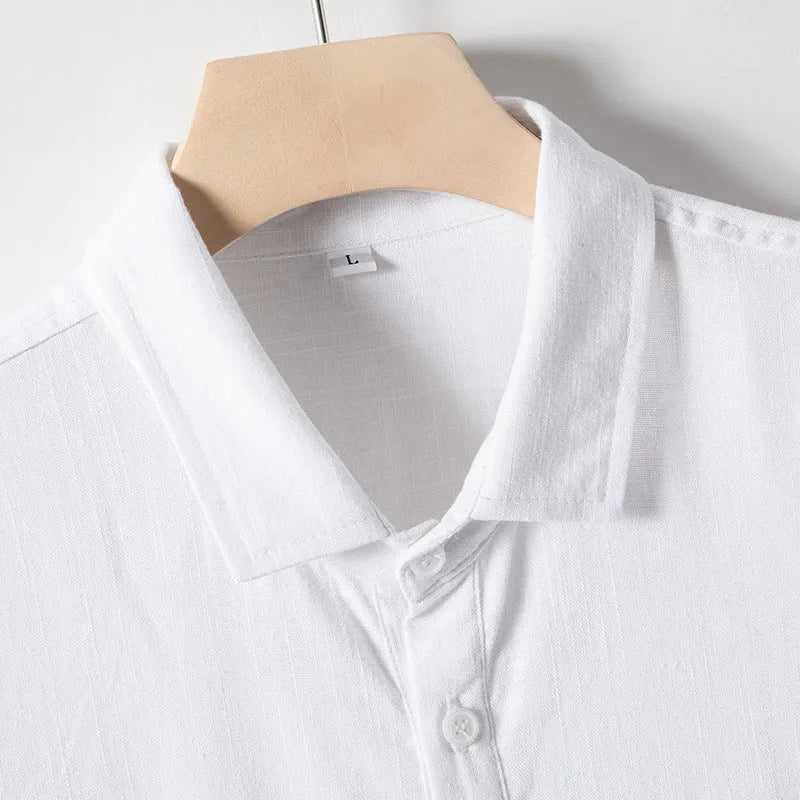 A man wearing a loose-fit, solid colour linen blend t-shirt with short sleeves.