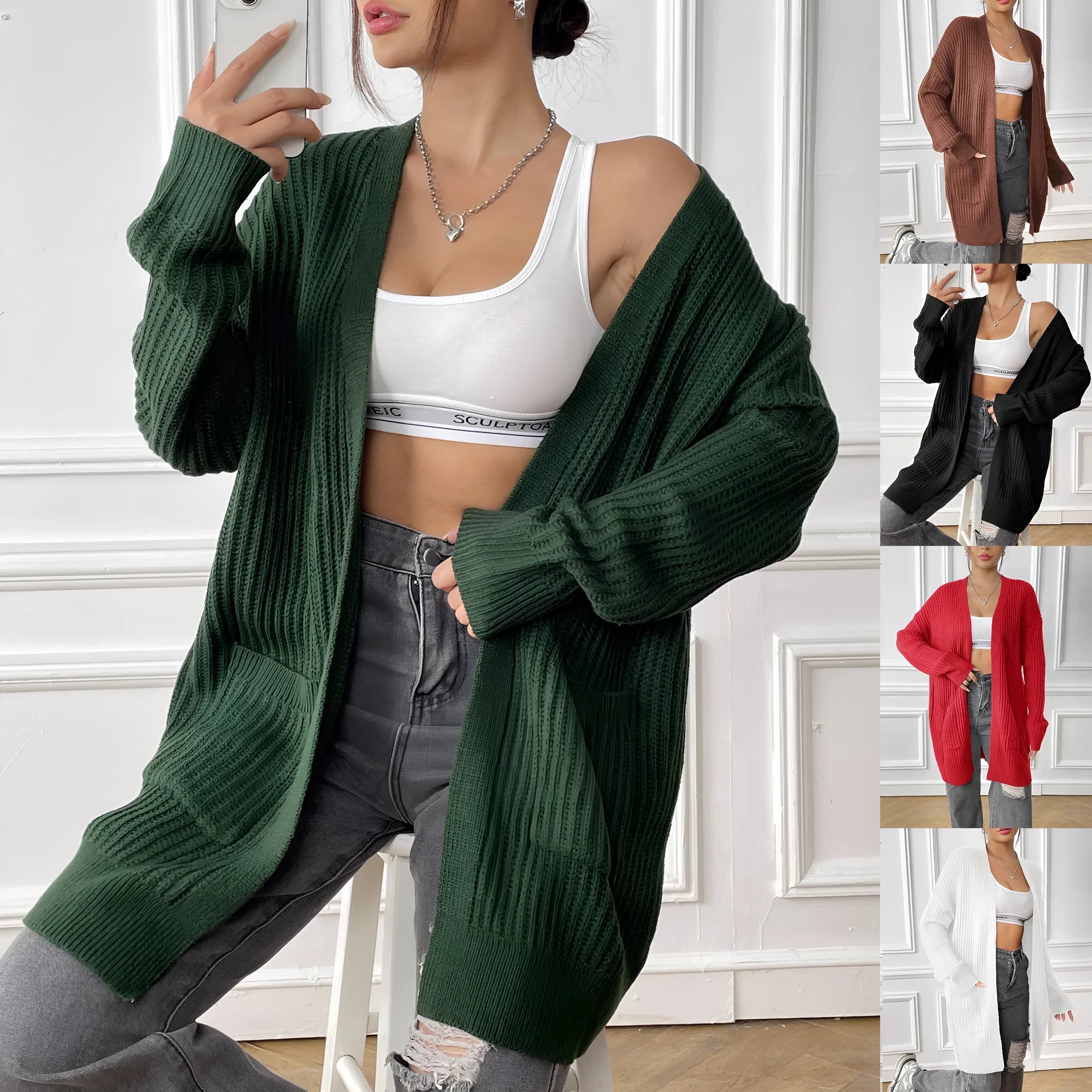 Women's dark green loose fit cardigan with two front pockets and long sleeves.