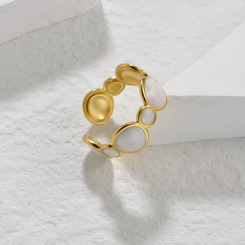 A geometric adjustable ring for women made of electroplated stainless steel on a plain background.
