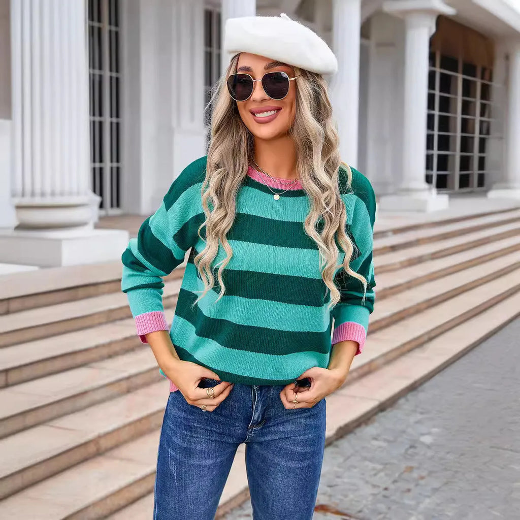 Women's loose fit acrylic knit sweater in blue with striped pattern, long sleeves and round neck.