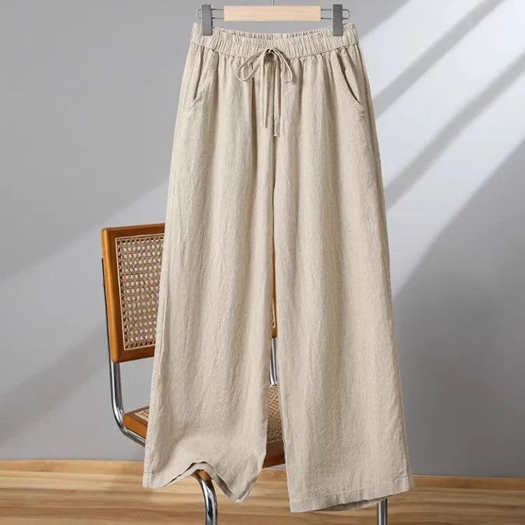 Women's apricot straight-leg casual trousers with elastic waist and drawstring detail laid flat