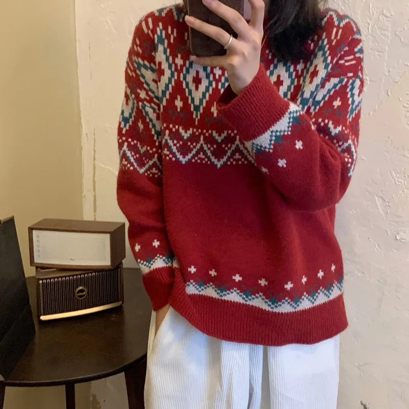 A woman wearing a loose red and white striped long-sleeved knitted pullover top.