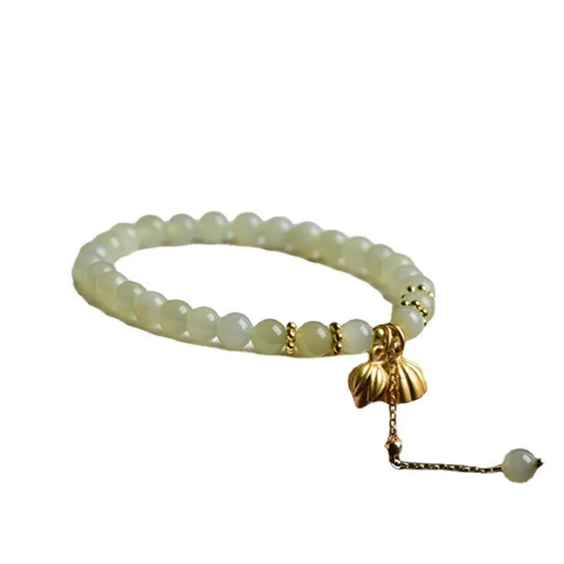 Two Shihuan natural Hetian jade bracelet with 6mm beads, fu charm, and lotus motif on a wrist.