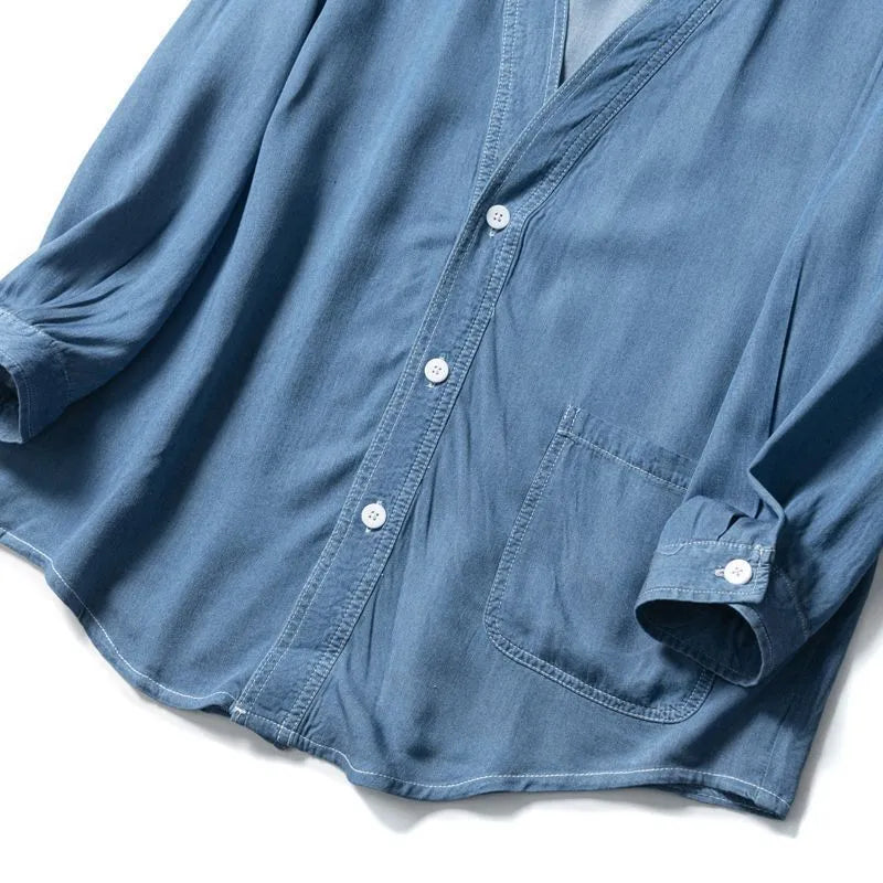 Men's dark blue casual denim coat with V-neck collar and chest pocket on a hanger.