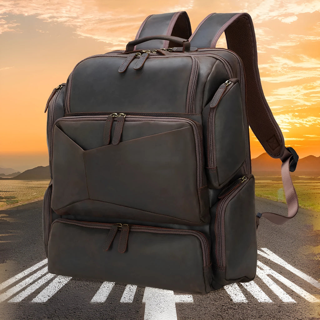 Dark brown retro crazy horse leather backpack for men open to show 17-inch laptop compartment and internal organisers.