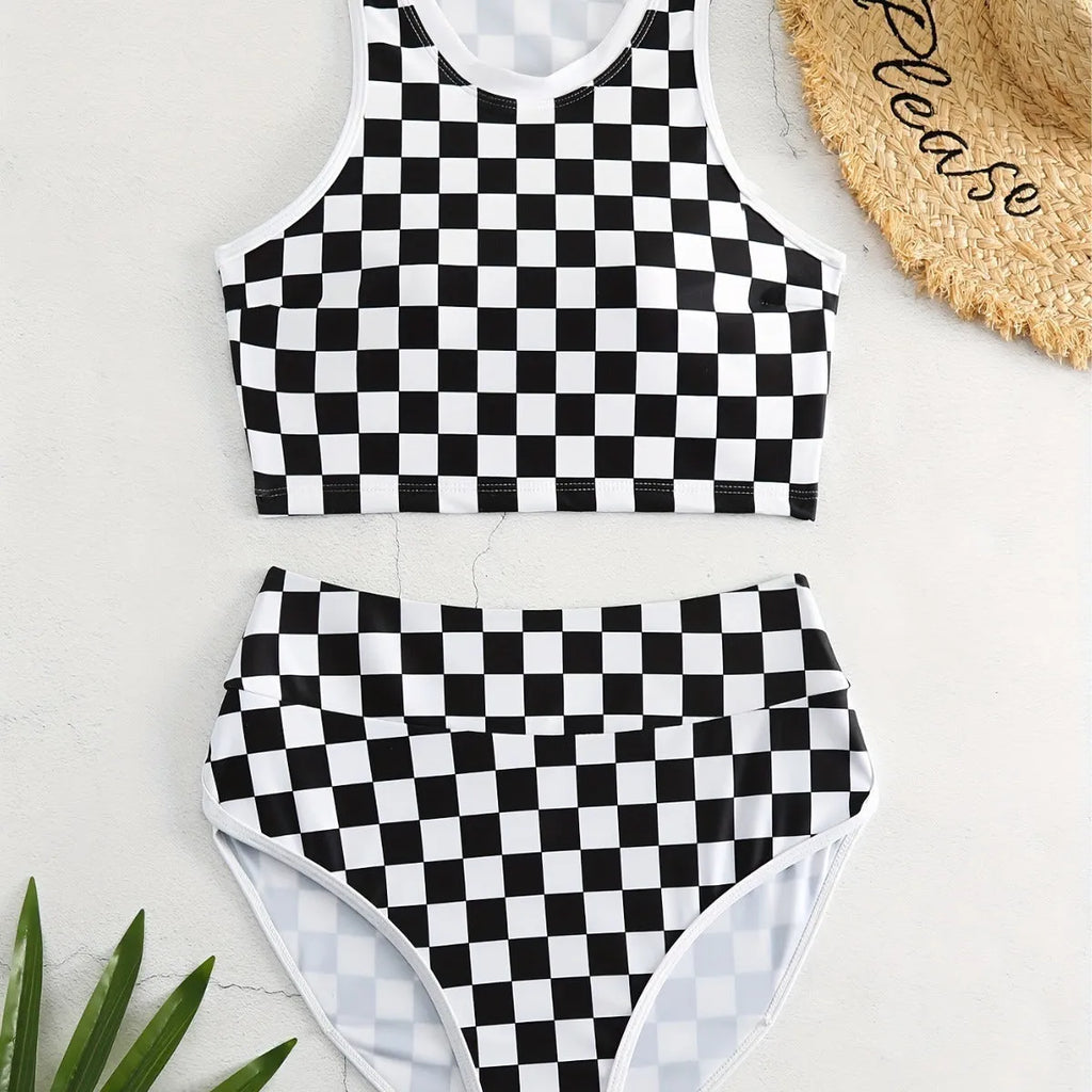 Backless one-piece women's swimsuit with black and white chessboard plaid pattern and white suspender straps.