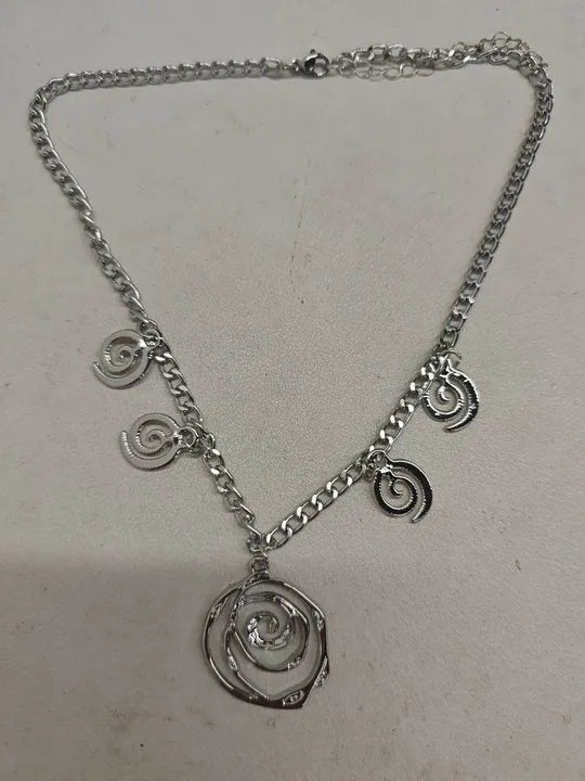 Spiral donut jewellery set showing necklace, bracelet, and earrings in geometric circle design with gold finish