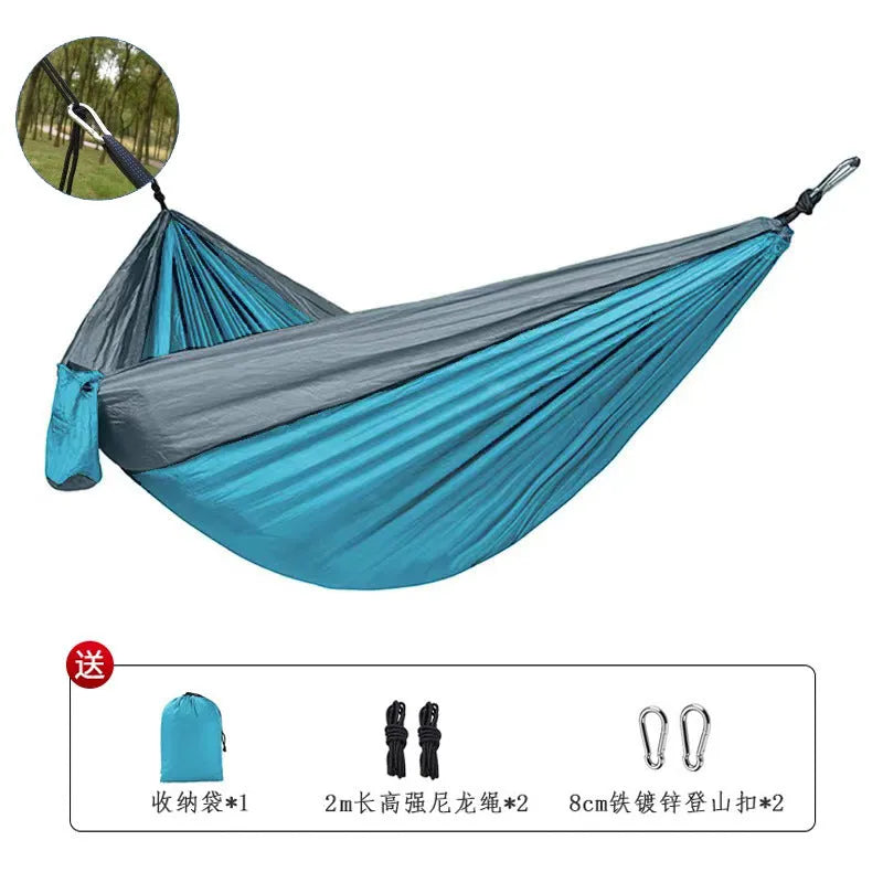 Blue nylon parachute cloth camping hammock hung between trees.