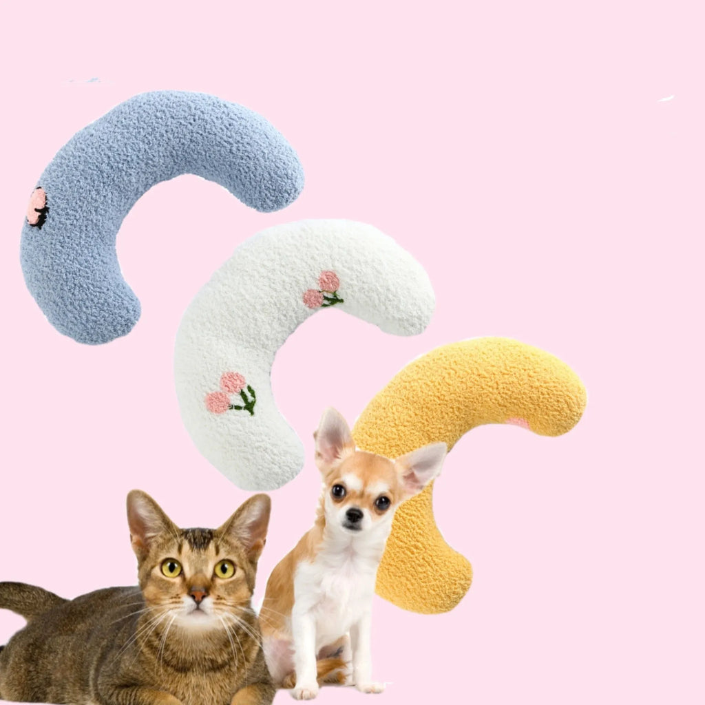 Blue U-shaped plush pet pillow for a small dog or cat, showing raised rim and quilted texture.