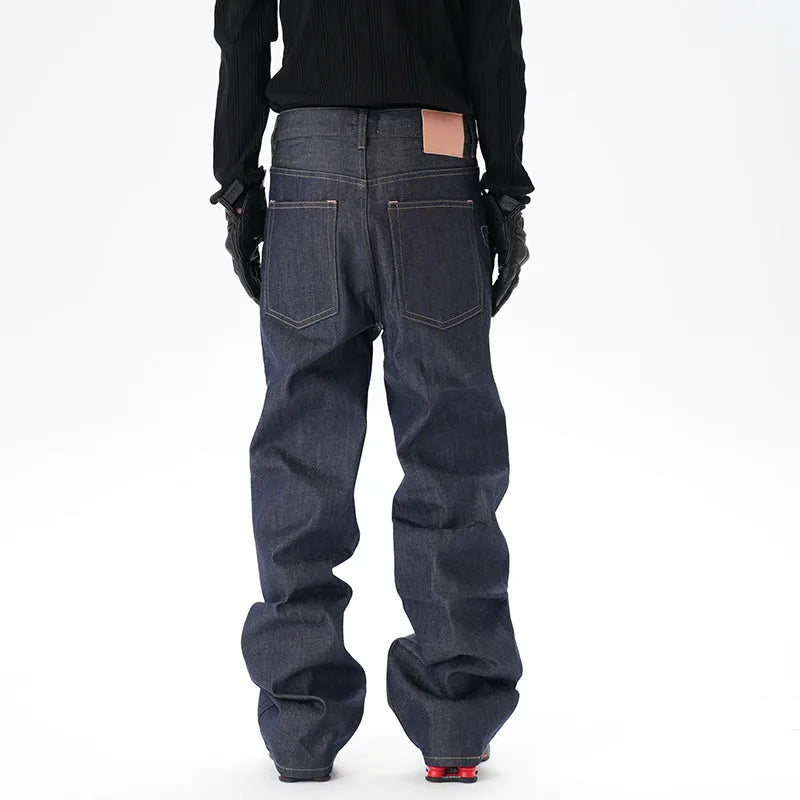A pair of dark blue loose-fit straight leg jeans on a neutral background.