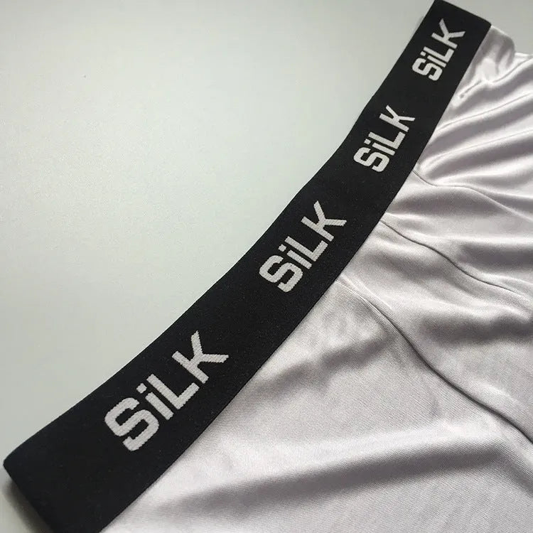 Men's navy blue silk shorts with mid-waist design on hanger